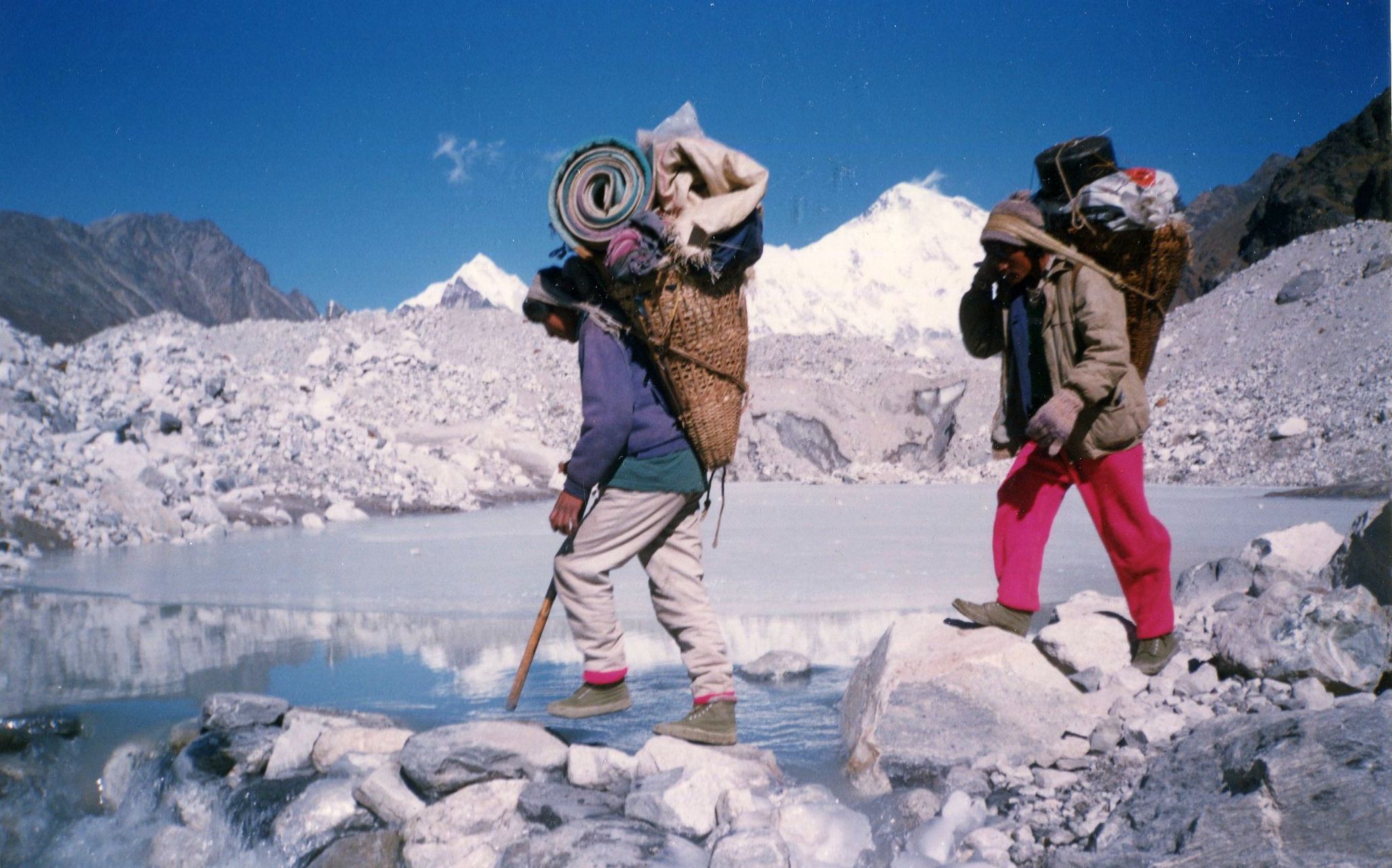 Porters Crossing Ngozumpa Glacier on route to Gokyo