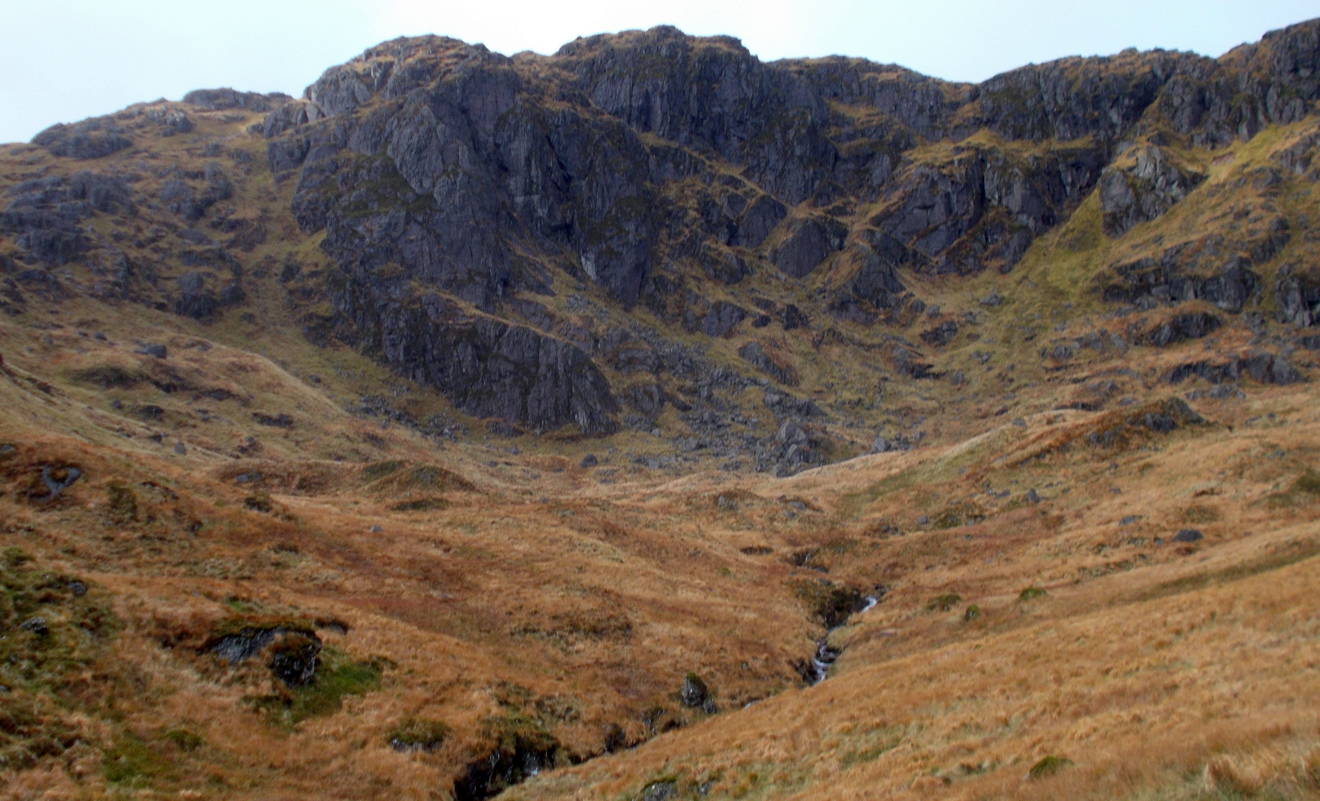 Rock cliffs beneath Ridge from Beinn Narnain to A'Chrois